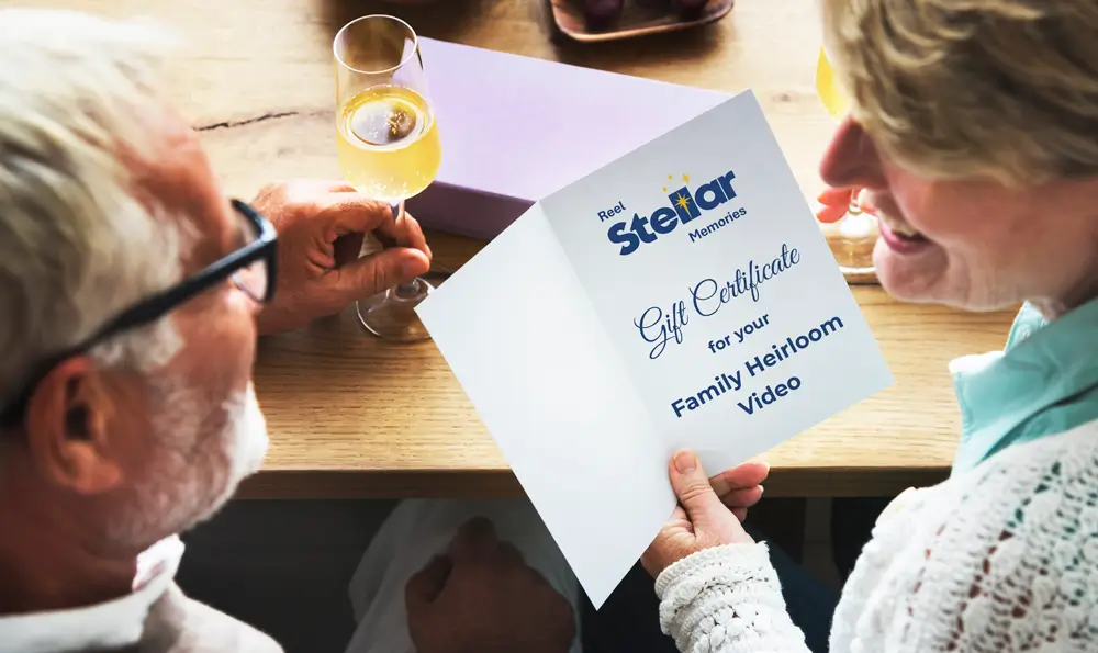 Happy couple with gift card | Reel Stellar Memories Fort Myers